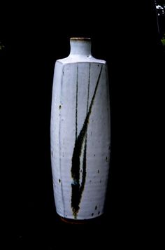 a large white vase sitting in the dark