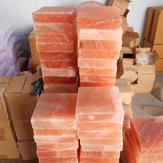 several pieces of raw fish are stacked on top of each other in front of boxes