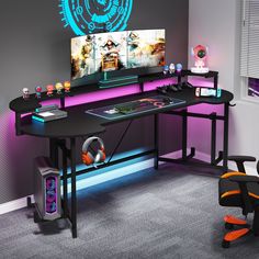 a computer desk with two monitors on top of it and an orange chair next to it