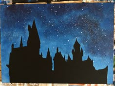 a painting of a castle with stars in the night sky above it, on top of a piece of paper