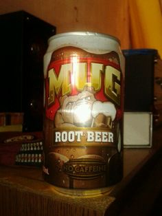 a beer can sitting on top of a wooden table