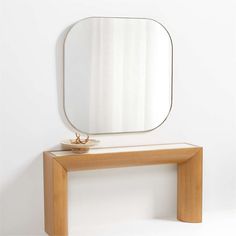 a mirror sitting on top of a wooden table