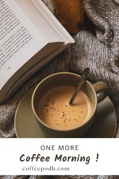 a cup of coffee sitting on top of a saucer next to an open book