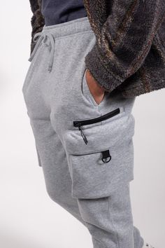 Introducing the Zip Cargo Pocket Fleece Sweatpants in Carpenter Style, crafted for the perfect combination of style and functionality. Made from 100% Poly Fleece, these sweatpants offer ultimate comfort and warmth. With a multitude of pockets including side pockets, side zip pockets, flap cargo pockets, and a back pocket, you'll have plenty of storage options for your essentials. The elasticated drawstring waist ensures a secure and customizable fit. Whether you're running errands or going for a Fleece Sweatpants, Cargo Pocket, Mens Sweatpants, Running Errands, Drawstring Waist, Side Zip, Zip Pockets, Brooklyn, Fitness Models