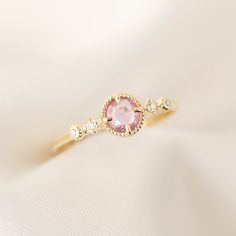 4.5mm Natural sapphire, unheated & untreated 0.04ctw G color SI clarity accent diamonds Band width: approx. 1.3mm Low profile four prongs setting Made of 100% recycled solid 14k gold and ethically sourced gemstones Colors may vary slightly as they are genuine gemstones Elegant Pink Sapphire Ring With Center Stone, Pink Sapphire Ring With Rose Cut Diamonds, Round Pink Sapphire Ring With Rose Cut Diamonds, Fine Jewelry Pink Topaz Promise Ring, Pink Topaz Promise Ring In Fine Jewelry Style, Pink Topaz Ring For Promise, Fine Jewelry Style, Pink Sapphire Gemstone Rings, Pink Sapphire Round Cut Ring, Pink Sapphire Ring With Ethical Diamonds