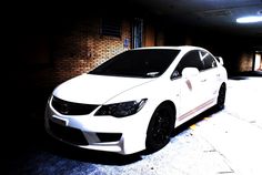 a white car parked in a parking garage