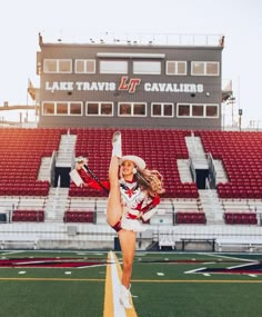 a cheerleader is dancing on the field in front of an empty bleachers