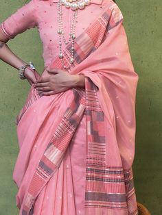 Indulge in the ethereal beauty of our baby pink cotton saree, adorned with intricate handwoven work, designed to elevate your style quotient for any occasion. This exquisite ensemble, measuring 5.50 meters, is a testament to timeless elegance and sophistication, making it the perfect attire for events, festivals, and special gatherings.
The soft and delicate hue of baby pink, coupled with the intricate weaving details, ensures that you make a graceful and captivating impression wherever you go. Pink Cotton Silk Traditional Wear For Festive Season, Pink Cotton Silk Traditional Wear For Transitional Season, Festive Pink Cotton Silk Traditional Wear, Transitional Pink Cotton Silk Traditional Wear, Festive Cotton Pre-draped Saree With Zari Weaving, Cotton Pre-draped Saree With Unstitched Blouse For Puja, Transitional Pink Cotton Silk Set, Pink Cotton Silk Traditional Wear For Navratri, Cotton Pre-draped Saree For Puja During Navratri