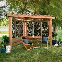 a wooden pergolan with chairs and plants around it