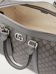 Gucci's versatile 'Ophidia' duffle bag works well for a weekend getaway or as an airplane carry-on. Made in Italy from the label's 'GG Supreme' coated-canvas, it's trimmed with leather and has sleek silver-tone hardware. The adjustable shoulder strap can be detached if you prefer to use the two top handles. Duffle Bag For Men, Airplane Carry On, Shop Gucci, Gucci Collection, Canvas Duffle Bag, Gucci Ophidia, Mr Porter, Grey Leather, Weekender Bag