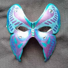 Butterfly mask - Hand-painted  Butterfly Mask. Full face party mask. The masquerade mask is Hand-painted with metallic gel pens and adorned with sparkling jewels. The mask is lined and attaches with an elastic strap. Great for Masquerade and Mardi Gras. Fits most. designAnn Original Mask See more at http://www.designAnn.etsy.com Butterfly Mask Design, Mask Butterfly, Aesthetic Mask, Mask Full Face, Lace Parasol, Butterfly Mask, Painted Butterfly, Theatre Masks, Mask Shapes