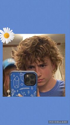 a young boy taking a selfie in front of a mirror with his cell phone