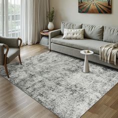 a living room with a couch, chair and rug