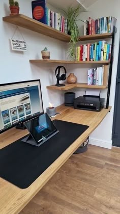 there is a computer on the desk in the room with bookshelves behind it