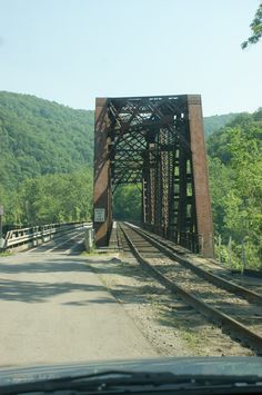 an old train trestle on the side of a road