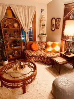 a living room filled with lots of furniture and decor on top of carpeted flooring