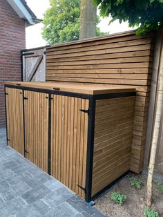 a large wooden shed sitting next to a tree