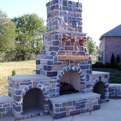 an outdoor brick pizza oven in the middle of a yard