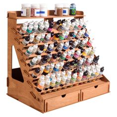 a wooden display case filled with lots of different types of paint on top of each other