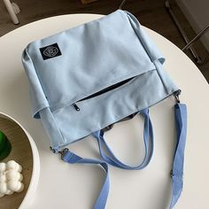 Multifunctional Softback Bag For Daily Use, Light Blue Large Capacity Backpack, Large Capacity Light Blue Backpack, Casual Yellow Bags With Zipper Closure, Canvas Bag With Zipper Closure For Daily Use, Daily Use Solid Canvas Bag With Zipper, Blue Multifunctional Bags For Daily Use, Canvas Pouch Bag With Zipper For Daily Use, Daily Use Canvas Bag With Zipper Closure