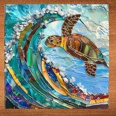 a sea turtle swimming in the ocean on a stained glass mosaic tile wall art piece