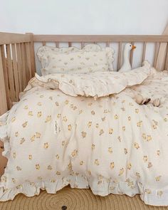 the bed is made with white linens and yellow flowers on it, along with two pillows