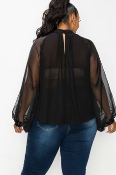 Elegant blouse with sheer back and sheer dolman sleeves. Neck line ornate with oversized bow. True Fit. 100% Polyester