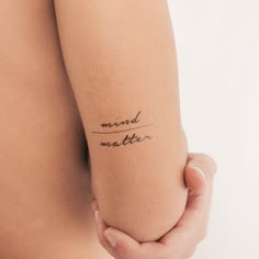 a woman's arm with the word mind matter written on it, in cursive writing