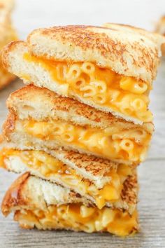 three grilled cheese macaroni and cheese sandwiches stacked on top of each other