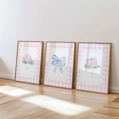 three framed pictures on the wall with a bow and flowers in them are sitting next to each other