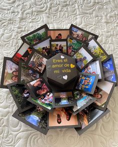 a bunch of pictures are arranged in the shape of a circle on top of a bed