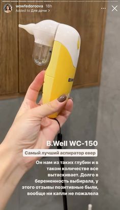 a person holding a yellow and white electric device in their hand with the words b well c - 150 on it