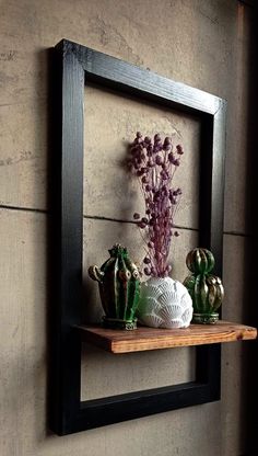 a wooden shelf with vases and flowers on it