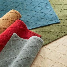 four different colored rugs on top of each other in various colors and sizes,