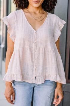 It's your choice if you get your hands on this top. However, let me tell you how fab this top is! That linen fabric is wonderfully light and that ruffled detailing is truly precious! This top is going to look so good with white jeans or shorts! This top features a v-neck, short sleeves, ruffled detailing, and a button down front. Material has no amount of stretch.Leanora is wearing the small. Actual product colors may vary from images shown due to different viewing devices and lighting. Feminine Flutter Sleeve Top With Ruffle Hem, Relaxed Fit Tops With Ruffles And Flutter Sleeves, Flowy Cotton Top For Summer, Flowy Feminine Top With Ruffle Hem, Feminine Flowy Top With Ruffle Hem, Flowy Feminine Tops For Casual Wear, Feminine Flowy Tops For Day Out, Flowy Feminine Tops For Day Out, Summer Ruffle Top With Flutter Sleeves