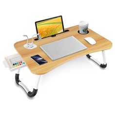 a laptop computer sitting on top of a wooden desk