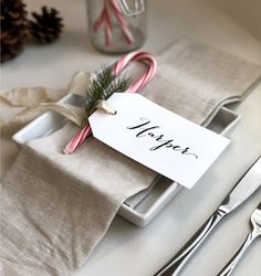 a place setting with candy canes and napkins