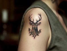 a man with a deer head tattoo on his arm