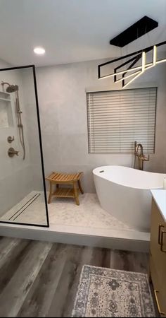 a bathroom with a large bathtub and wooden stool