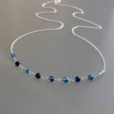 Genuine, premium-quality, shaded Kanchanaburi blue sapphire beaded choker/necklace, wire-wrapped in sterling silver This dainty and elegant choker/necklace is designed with genuine, 3.5 mm, micro-faceted ombré Kanchanaburi blue sapphire gemstones wire-wrapped to form a chain of linked gemstones as the frontal segment, measuring 2.5 inches and linked to a dainty but sturdy sterling silver chain. These gemstones are finely-faceted, highly polished and; while tiny, reflect light beautifully.  This Cheap Blue Jewelry With Silver Beads, Cheap Blue Adjustable Chain Necklace, Cheap Blue Chain Necklace With Adjustable Chain, Cheap Blue Jewelry With Silver Chain, Cheap Blue Jewelry With Natural Stones, Cheap Blue Beaded Necklace For Gift, Cheap Blue Beaded Chain Necklace, Affordable Blue Metal Chain Necklace, Cheap Handmade Blue Jewelry