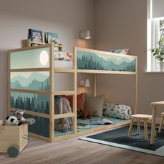 a child's bedroom with a bunk bed and desk in front of the window