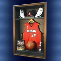 a basketball jersey and shoes are on display in a shadow box