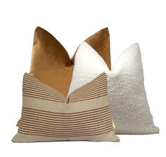 two pillows sitting next to each other on a white surface