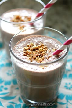 two glasses filled with smoothie on top of a table