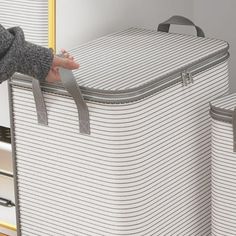 a woman is holding onto two suitcases in front of a mirror with her hand on the handles