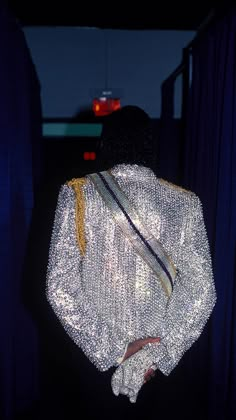 the back of a woman's jacket with sequins on it