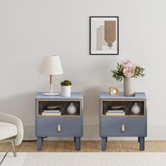 two blue nightstands with flowers on them in a living room