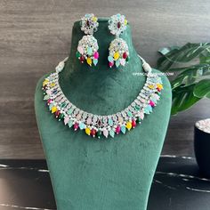 Anvi Multicolor Silver Polki Necklace Set with Maangtikka. Expertly crafted with precision and intricate detailing, the Anvi Multicolor Silver Polki Necklace Set with Maangtikka is a must-have statement piece for any occasion. The stunning multicolor stones and shimmering silver polki add a touch of elegance and sophistication to any outfit. Elevate your style and make a bold statement with this exquisite jewelry set. Polki Necklace Set, American Diamond Necklaces, Oxidized Necklace, Polki Necklace, Western Earrings, Ethnic Necklaces, Ethnic Earrings, Kundan Necklaces, Barbie Collection