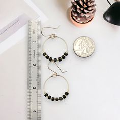 These gold hoops, adorned with black jasper beads, add a touch of eclectic elegance to any outfit. Perfect for any boho babe, these earrings are a must-have for your collection. 14k Gold Filled Wire Measure approximately 1.125" in diameter Earrings Hang 1.75" from top of ear wire Black Jasper Gemstones Polished to a high shine Sent in a Gift Box with Polishing Cloth Handmade in Montana 14k Gold Filled Beaded Round Earrings, Black Hypoallergenic Hoop Earrings For Everyday, Hypoallergenic Black Hoop Earrings For Everyday, Everyday Nickel-free Jewelry With Round Beads, Everyday Black Hypoallergenic Hoop Earrings, Black Small Hoop Metal Jewelry, Black Metal Small Hoop Jewelry, Small Black Metal Hoop Jewelry, Nickel Free Black Round Bead Earrings