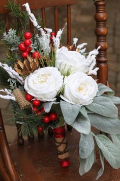 a bouquet of flowers sitting on top of a wooden chair next to a christmas tree